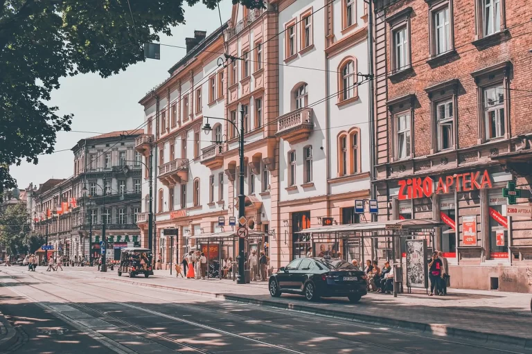 Krakow city map, pen and coffee cup on a wooden table, trip-planning flat lay