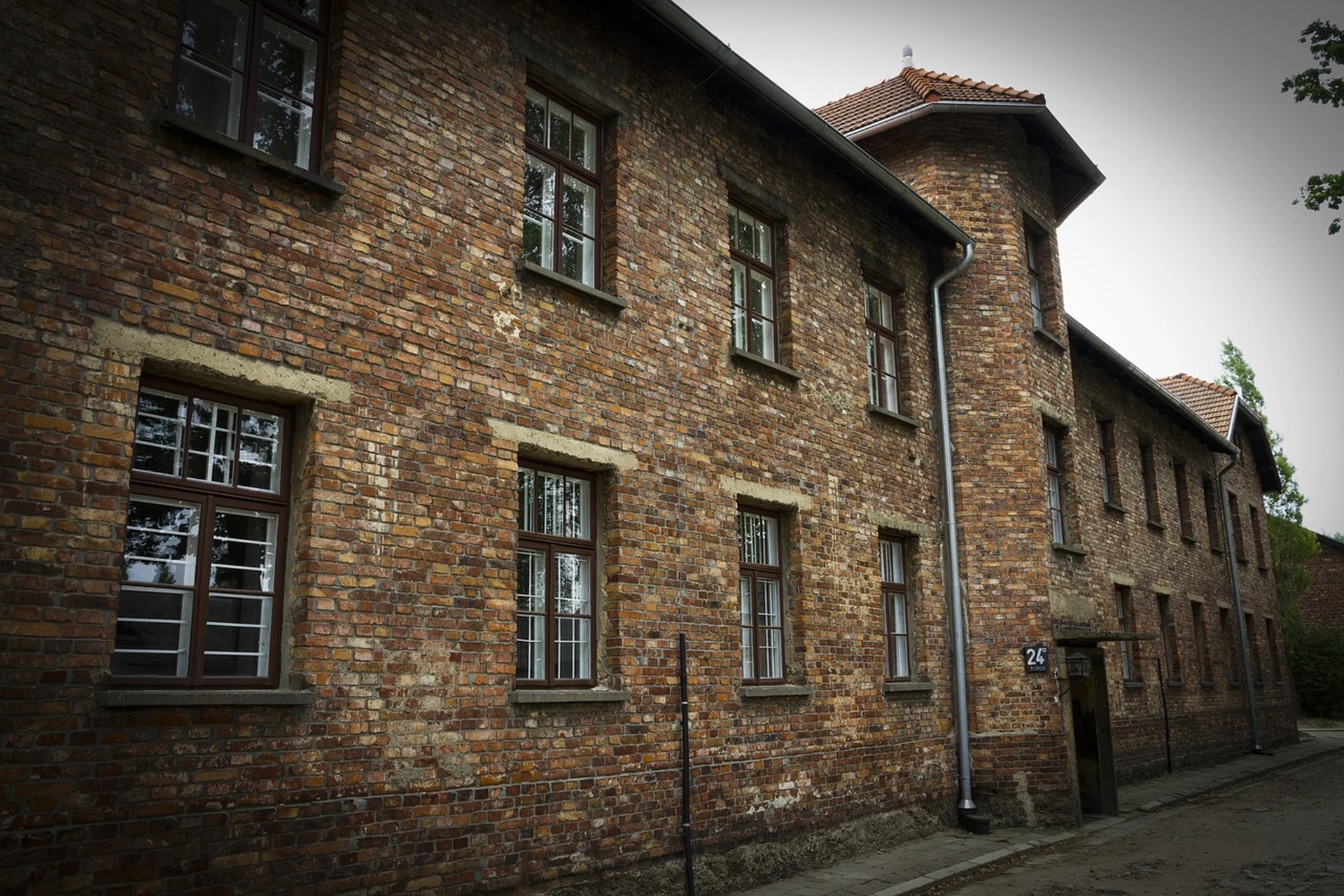 Overcast grey sky over the Auschwitz memorial site, wide shot
